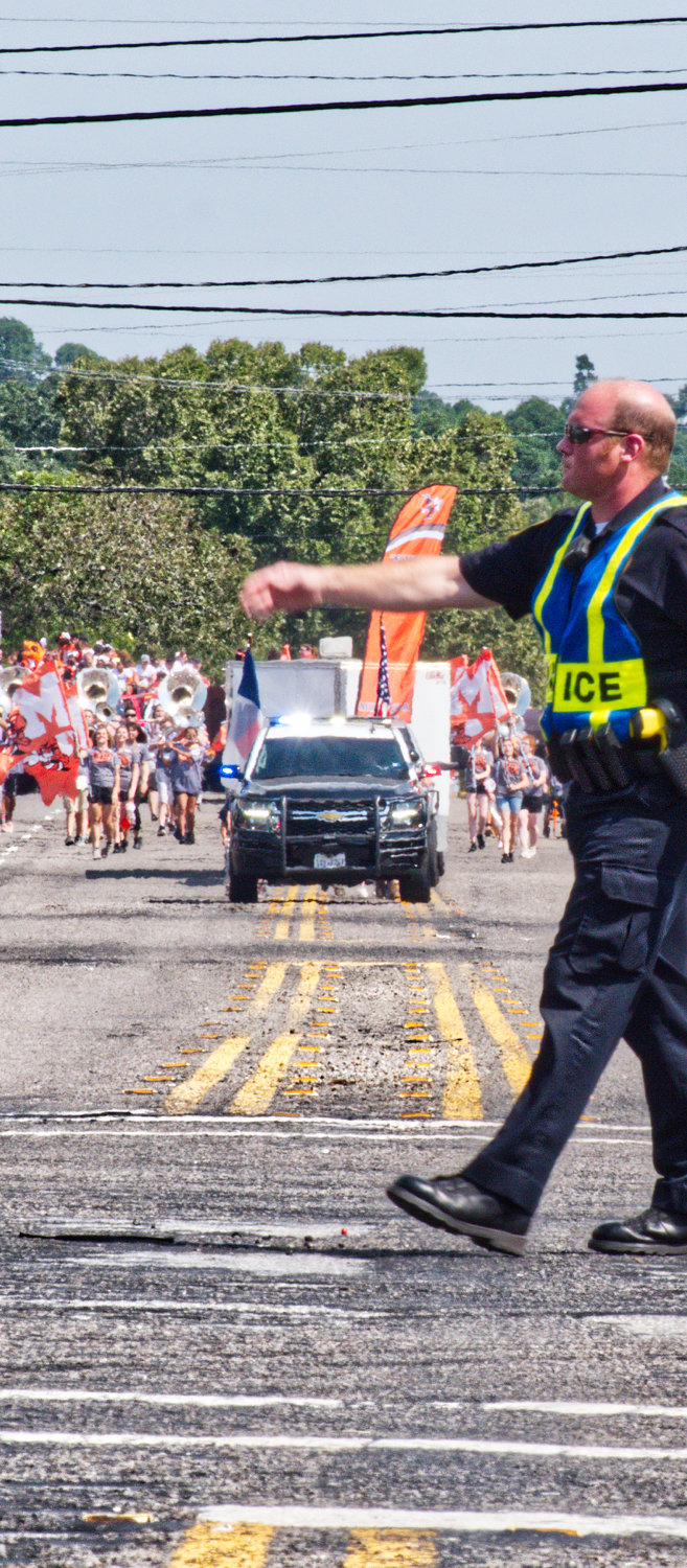 Police Capt. Dusty Cook directs traffic along Hwy. 80 as the parade approaches.